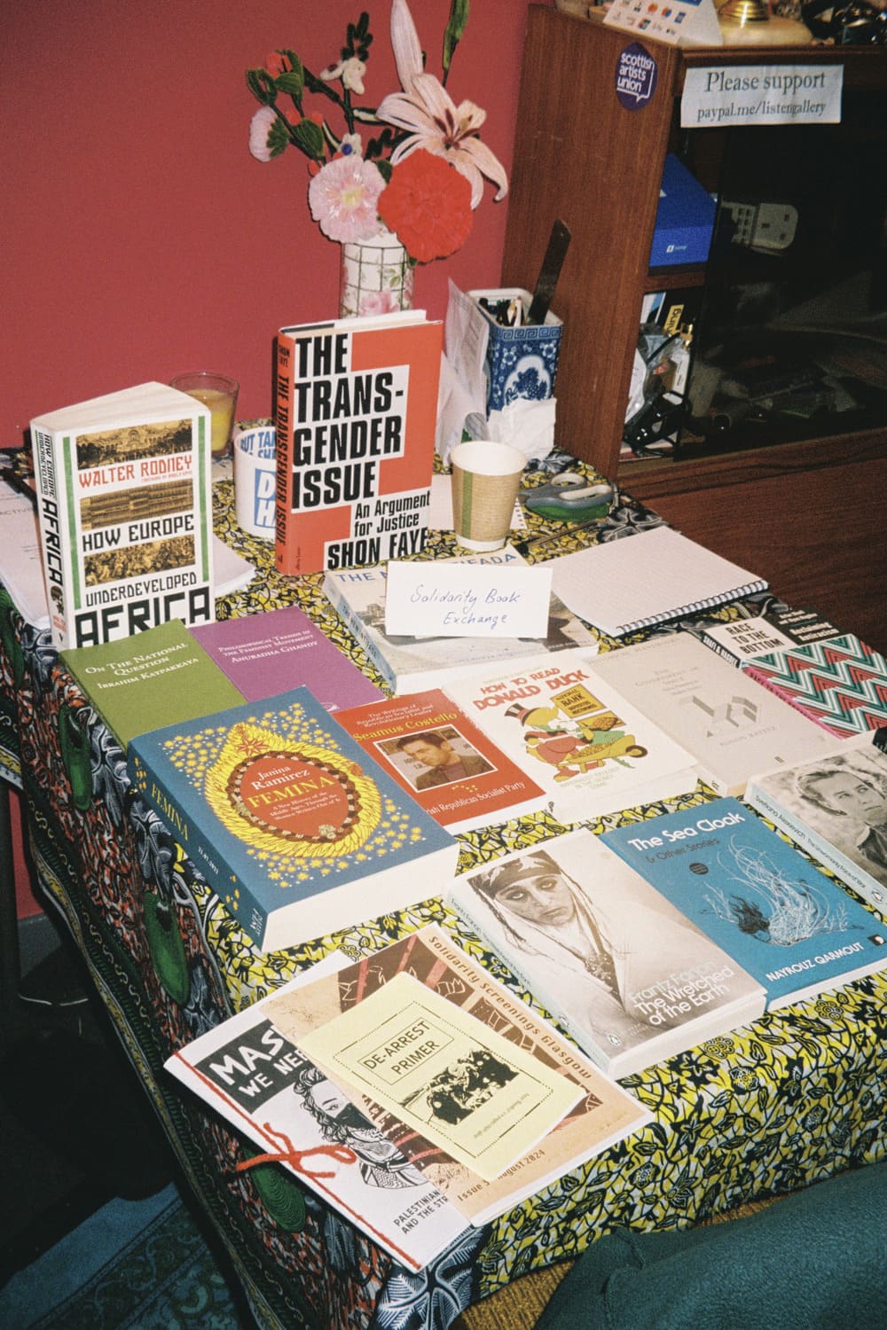 The Solidarity Book Exchnage setup in the enterance area of Listen Gallery