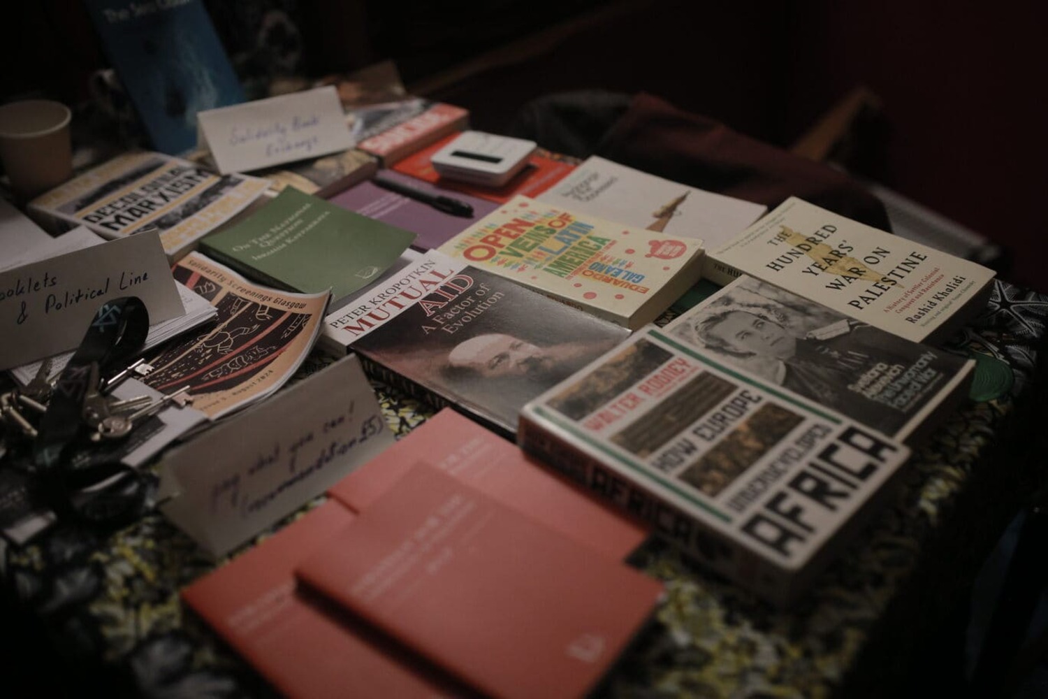 Table at the enterance of Listen Gallery set up with the Solidarity Book Exchange. Alongside this there are books for sale related to the 'A Night of Palestinian Shorts' screening as well as our booklets and political line