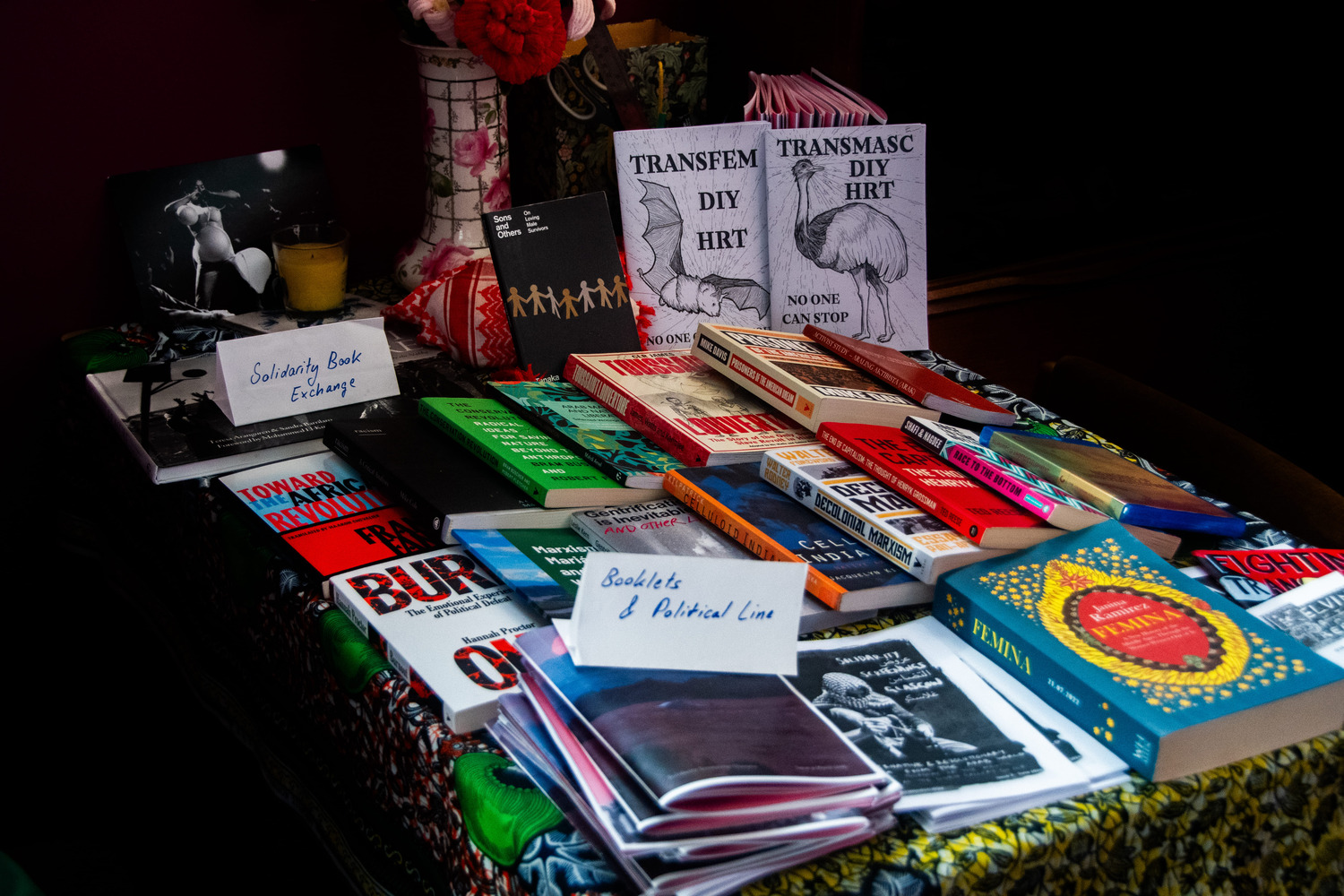 Table at the enterance of Listen Gallery set up with the Solidarity Book Exchange. Issue 4 of our booklet alongside some trans healthcare zines are setup with the book exchange for anyone to take copies.