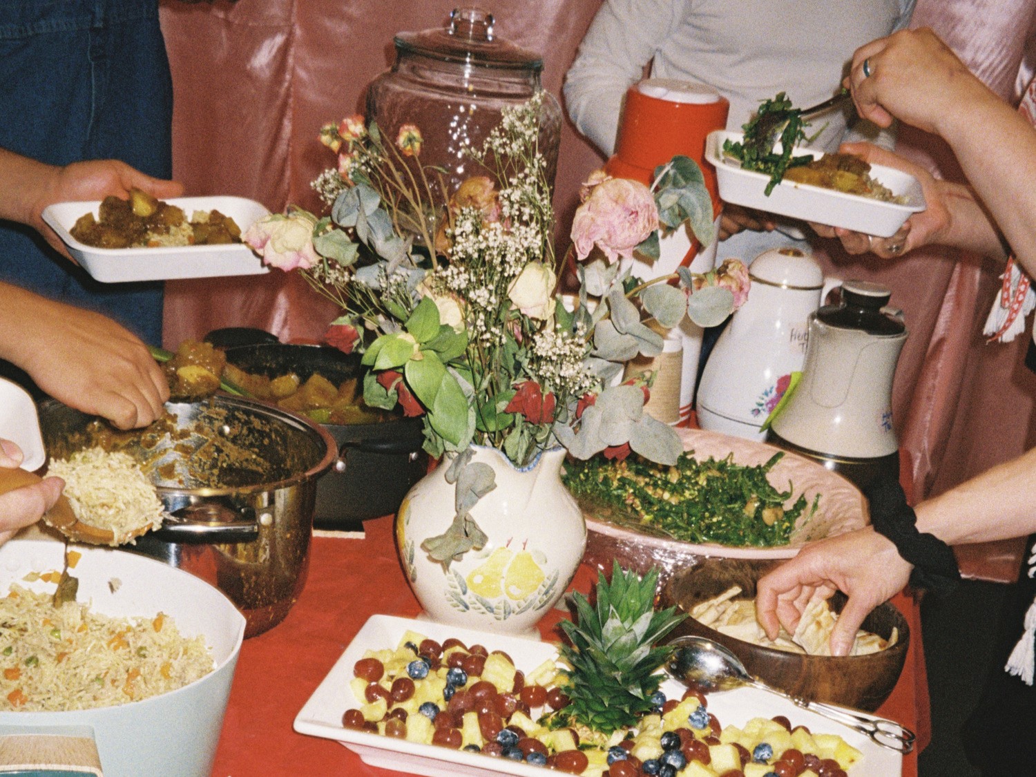 The table with the community meal for the 'Iraq: The Land of the Two Rivers' screening with various people helping themselves to food.